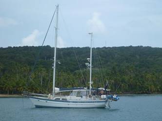 A small boat in a large body of water

Description automatically generated
