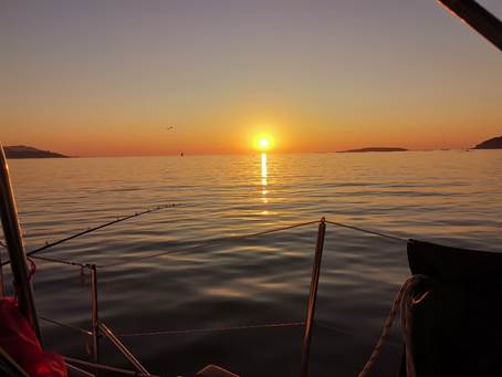 A sunset over a body of water

Description automatically generated with medium confidence