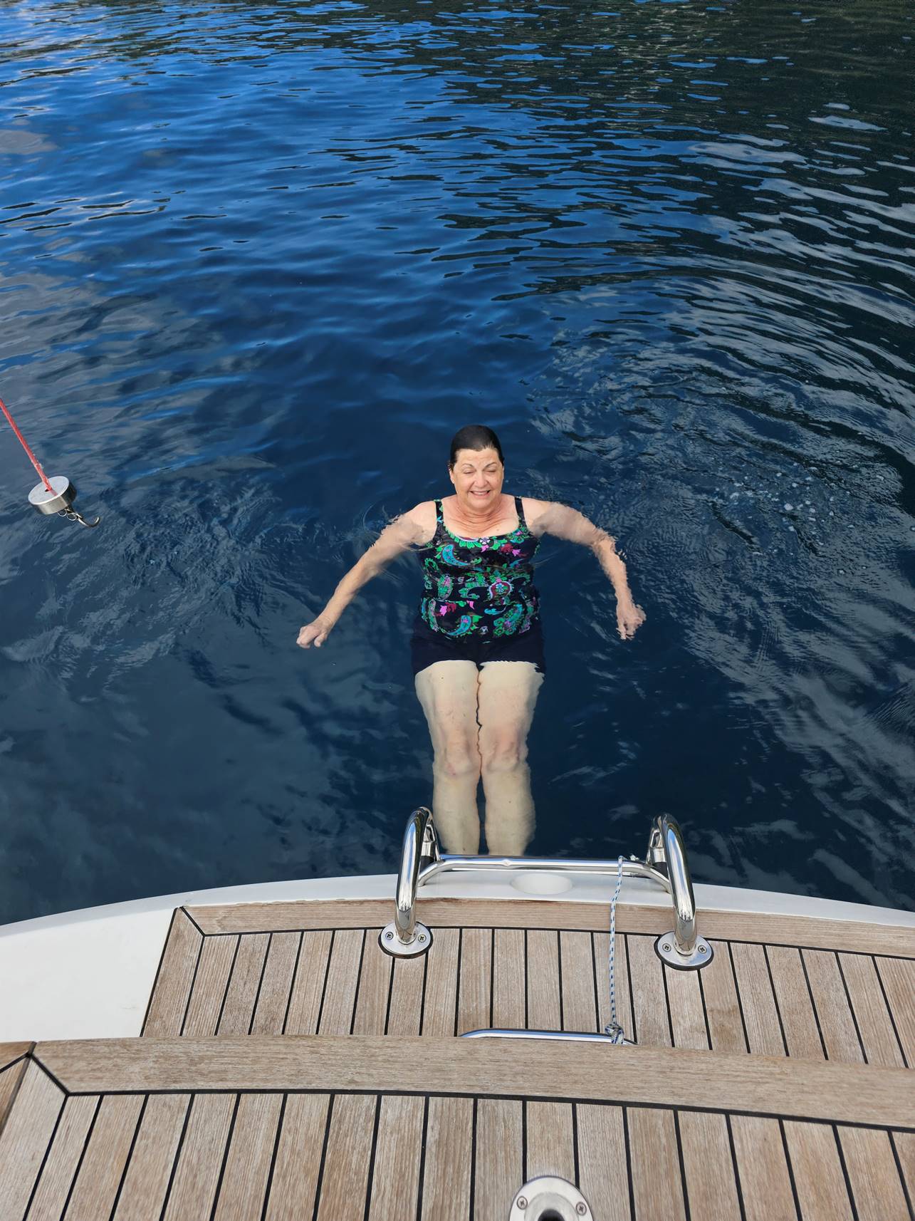 A person in a swimsuit in the water

Description automatically generated