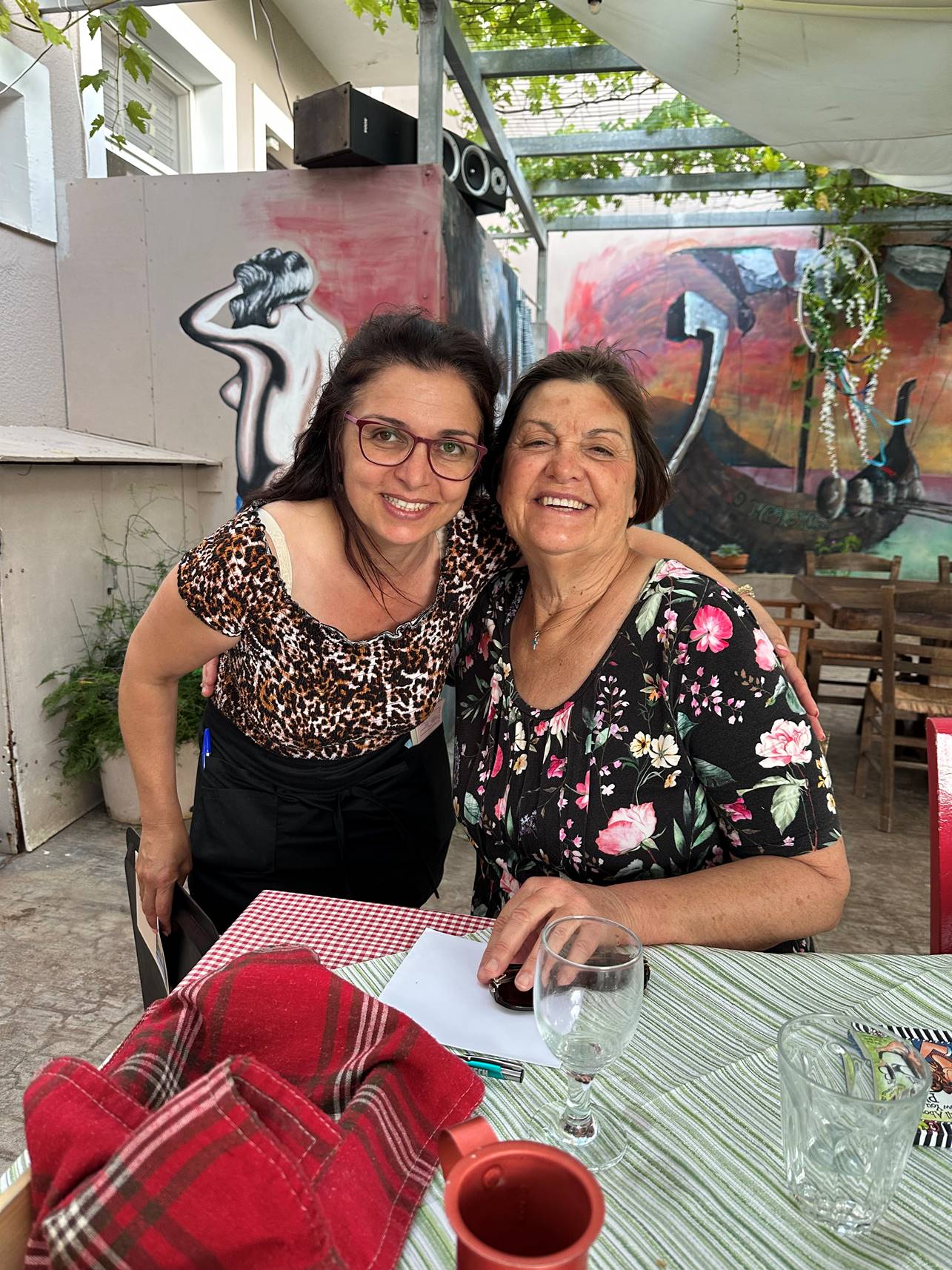 Two women sitting at a table

Description automatically generated