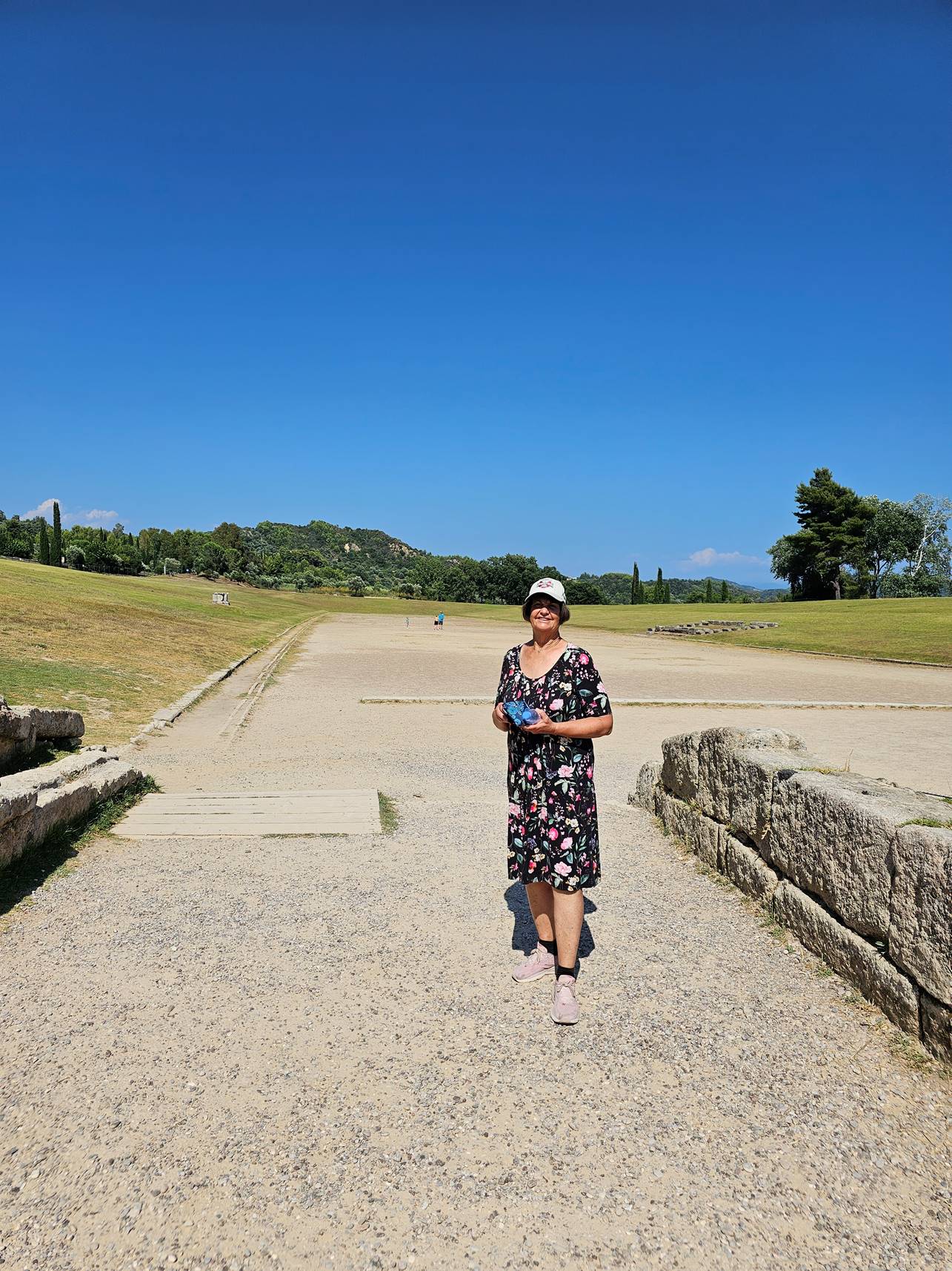 A person standing on a gravel path

Description automatically generated