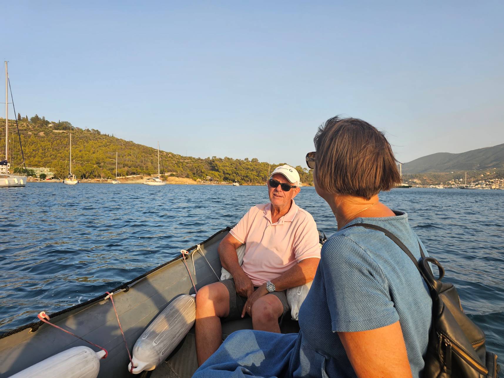 A person and person sitting in a boat

Description automatically generated