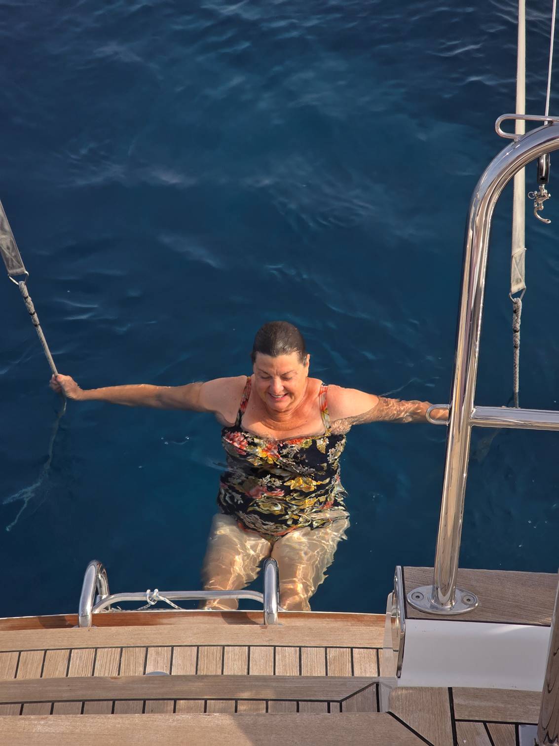 A person in a swimsuit on a boat

Description automatically generated