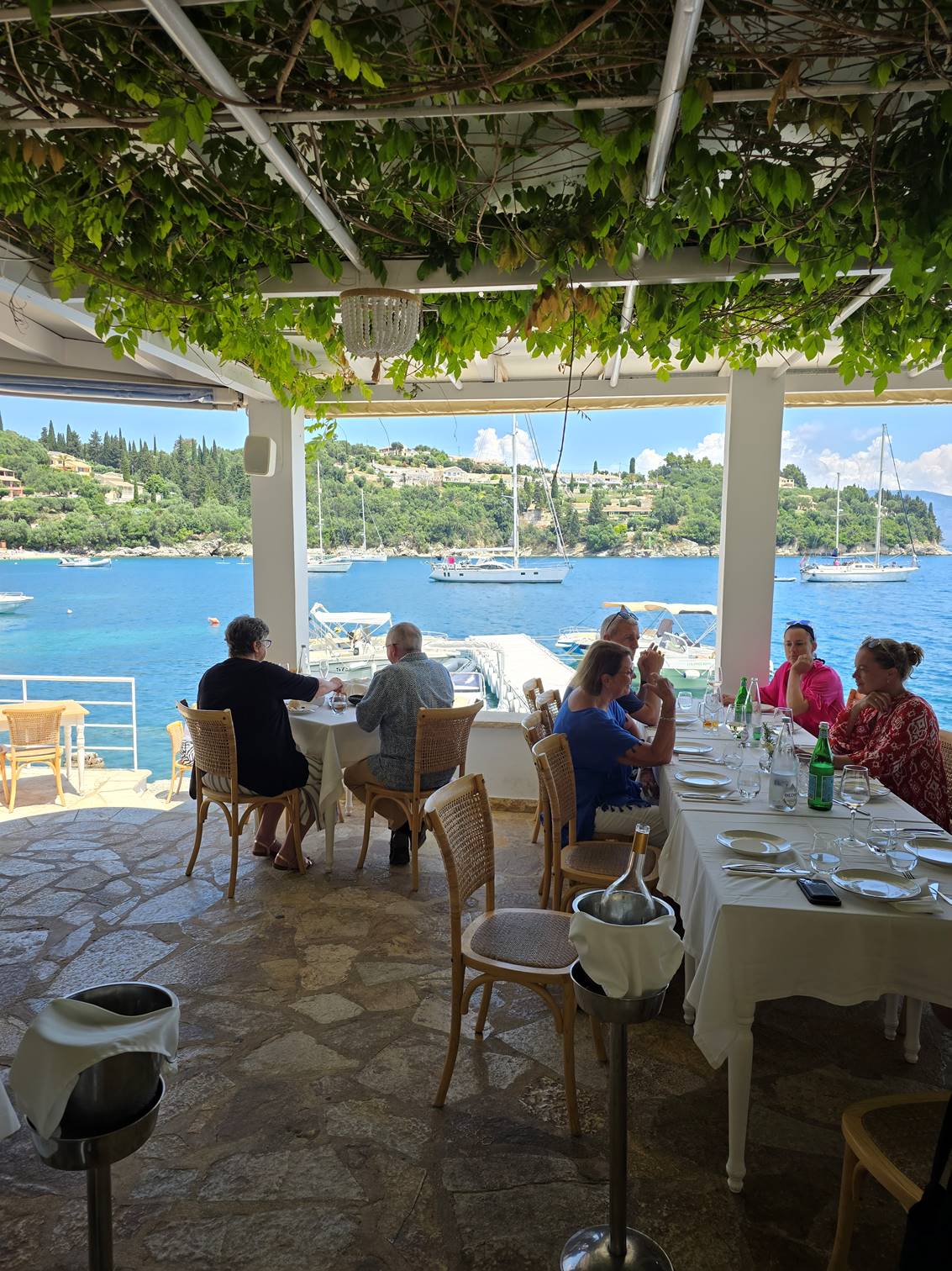 A group of people sitting at tables outside

Description automatically generated