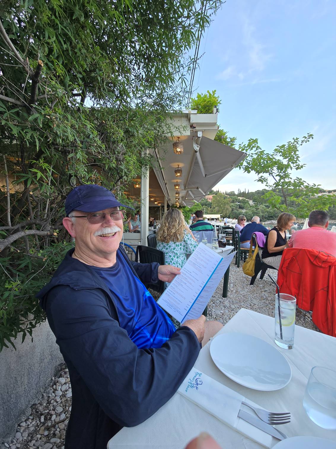 A person sitting outside with a paper

Description automatically generated