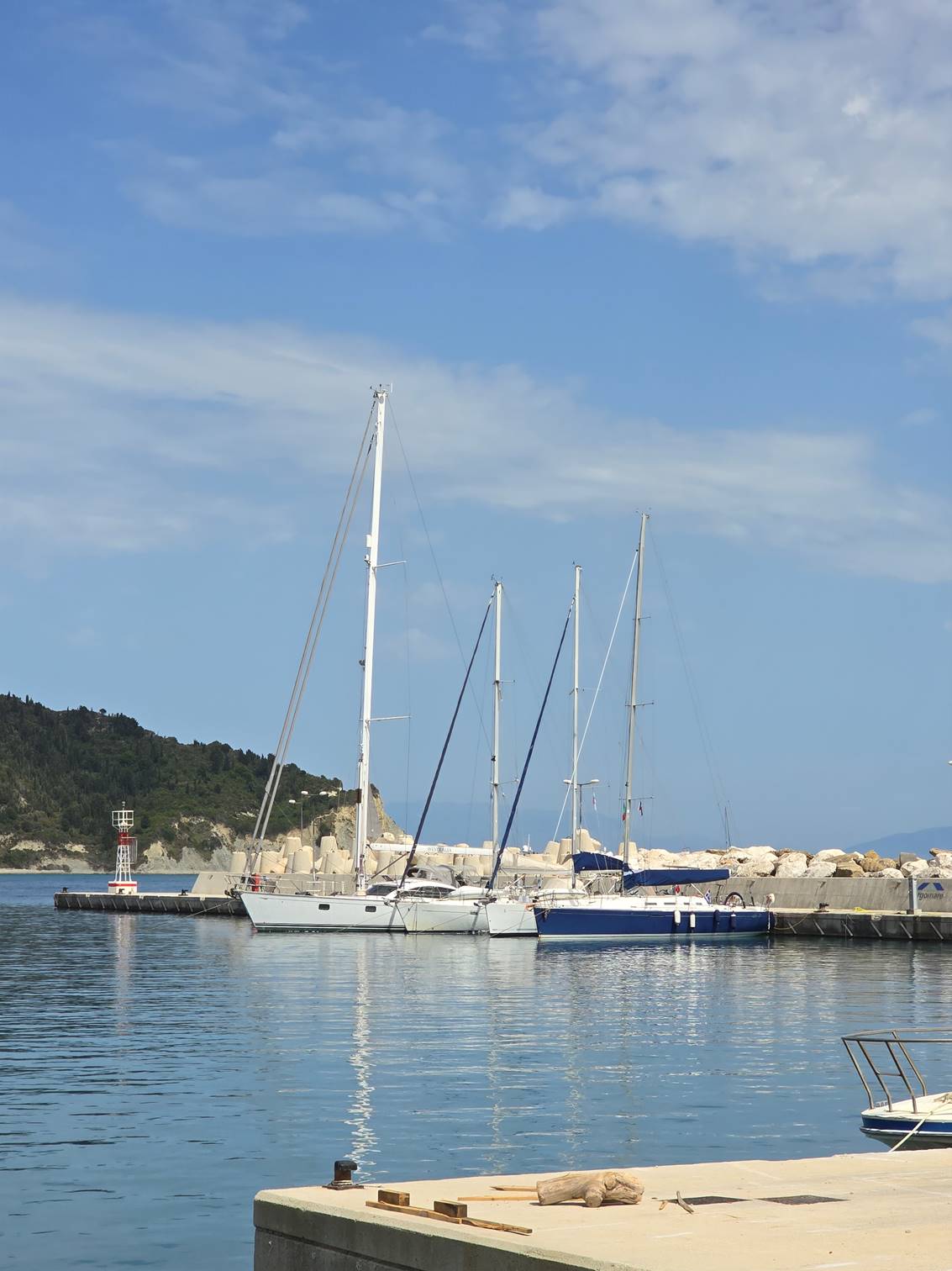 A sailboat docked at a dock

Description automatically generated