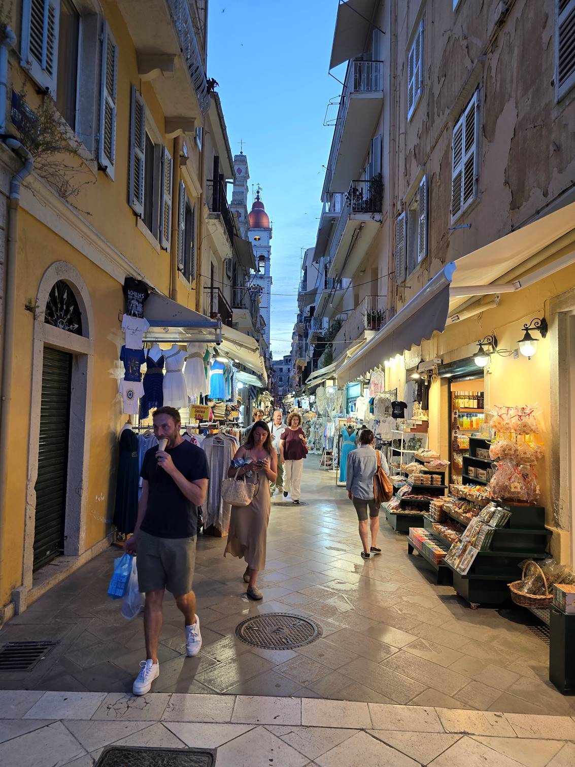 A group of people walking down a street

Description automatically generated