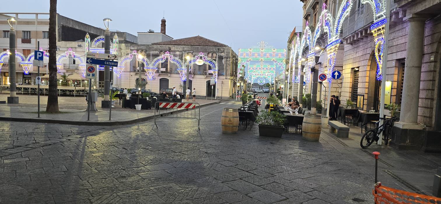 A street with tables and chairs

Description automatically generated