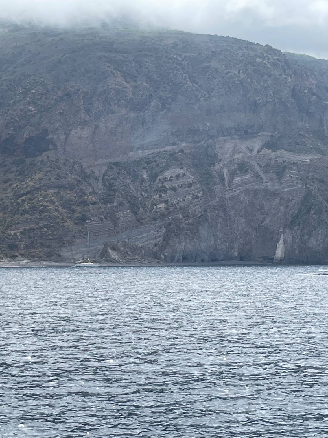 A body of water with a mountain in the background

Description automatically generated