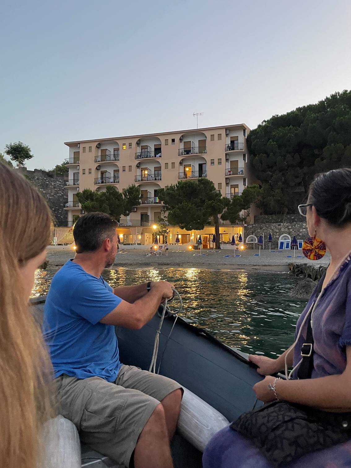 A group of people sitting on a boat

Description automatically generated